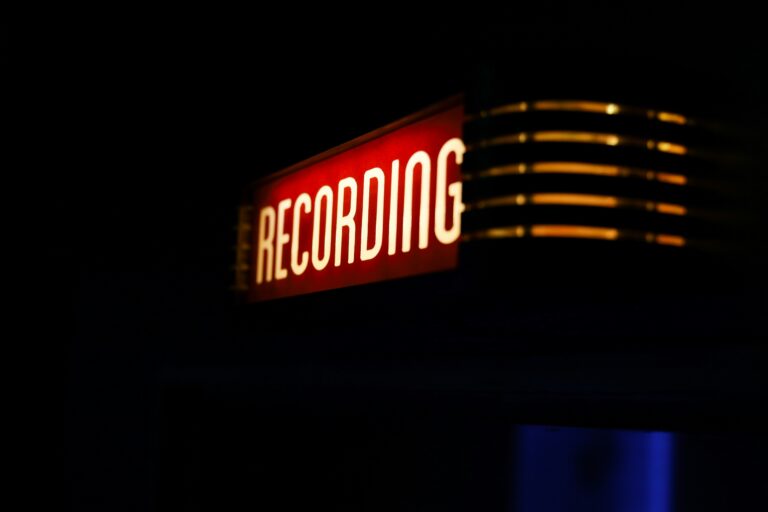 Illuminated red recording sign in a professional remote podcast recording studio