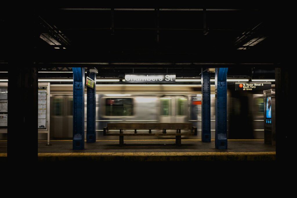 A long exposure shot of an NYC subway train at Chambers Street station, hinting at the unique soundscapes of the underground urban transit system