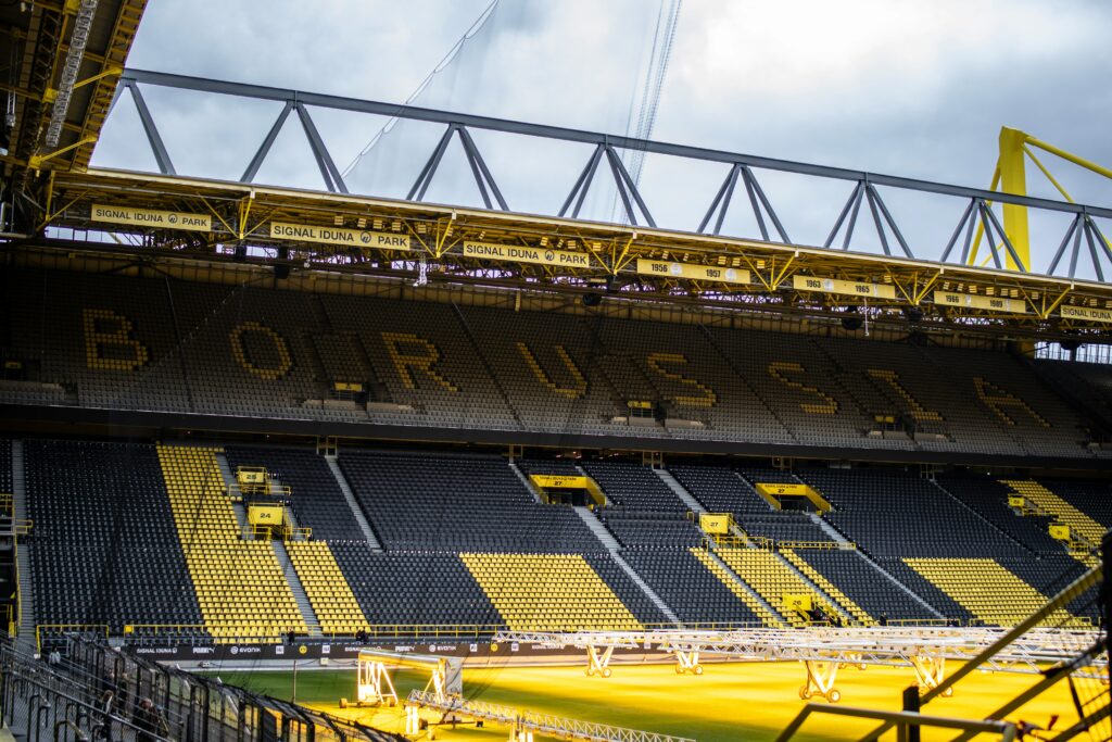 Rows of yellow and black seats fill Signal Iduna Park, setting the stage for the 'Yellow Wall' section, renowned for contributing to the stadium's overwhelming matchday soundscapes